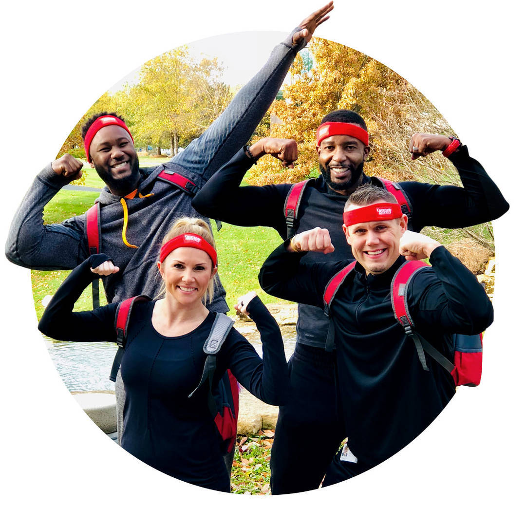Four enthusiastic CommunityAmerica employees celebrating a fitness challenge victory.