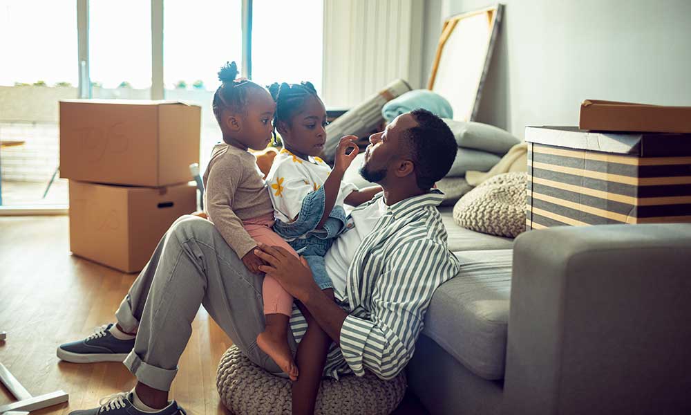 father with his two daughters in new home