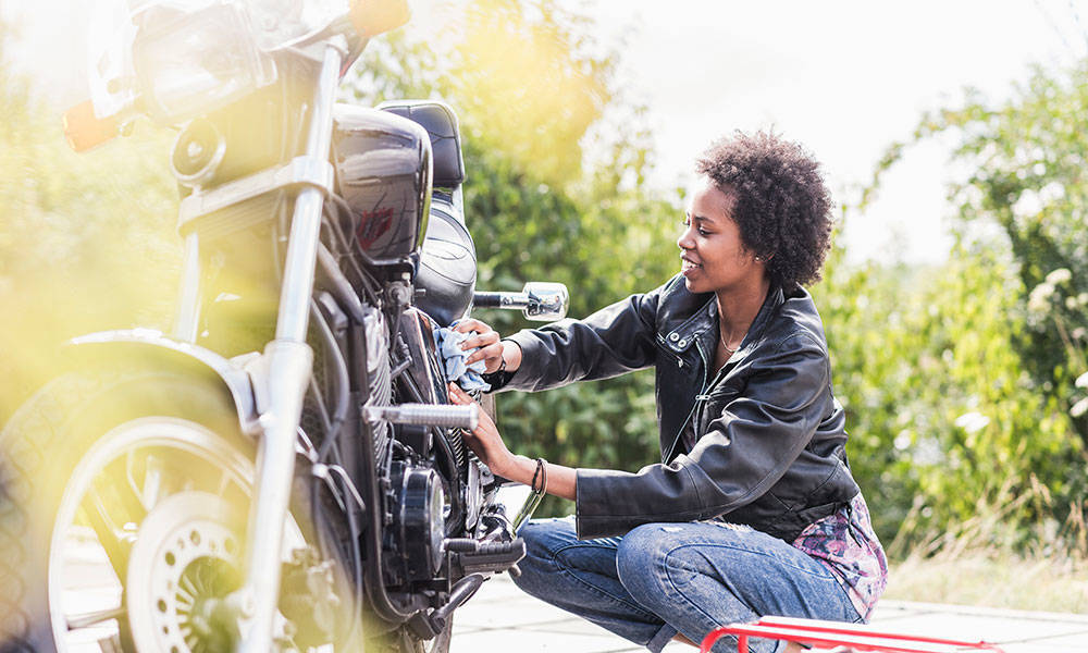 young woman detailing her motorcycle