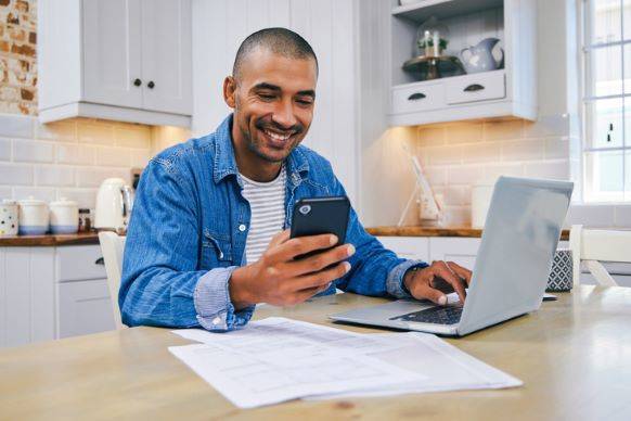 Man Using Budgeting App on Phone to Achieve Financial Goals