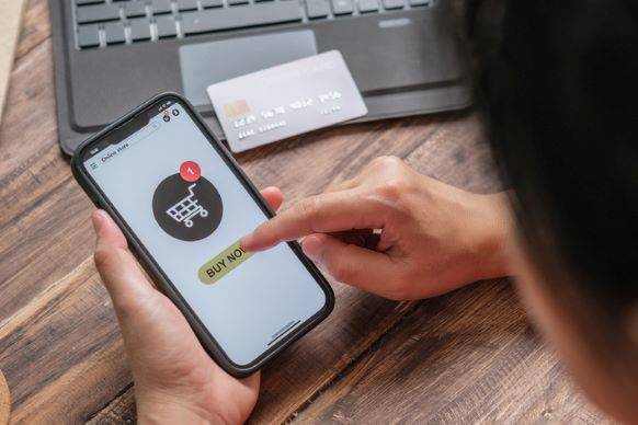 Person Adding Item to Cart via Online Shopping on Mobile Device