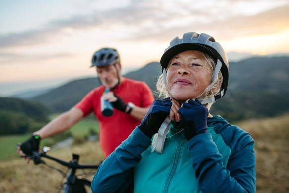 Elderly couple enjoying retirement while biking through the mountains.