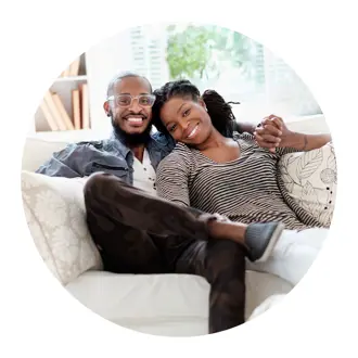 Happy Couple Holding Hands and Sitting on Couch in Circle